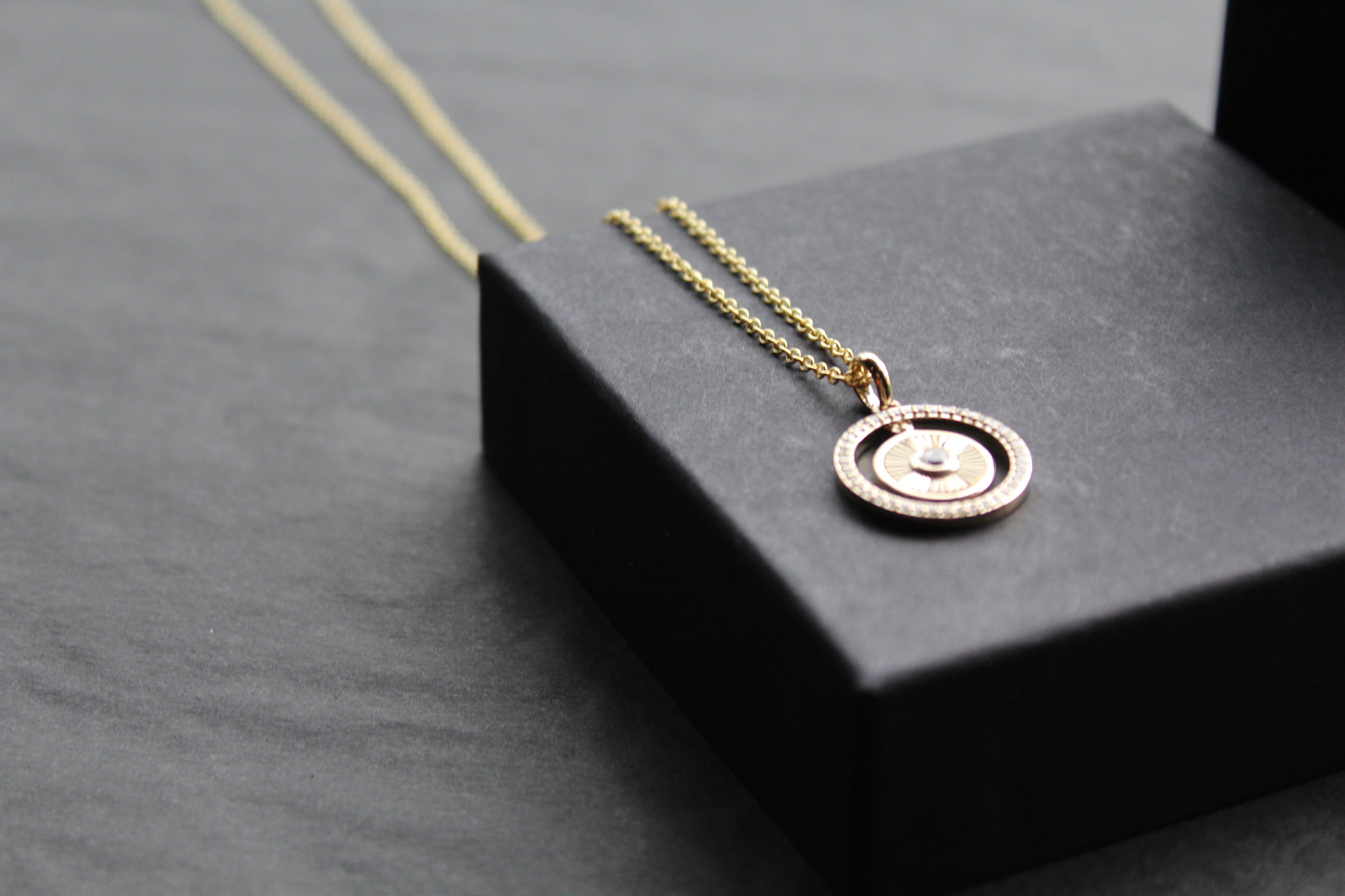 Small Sunburst Circle with Cubic Zirconia Halo Surround