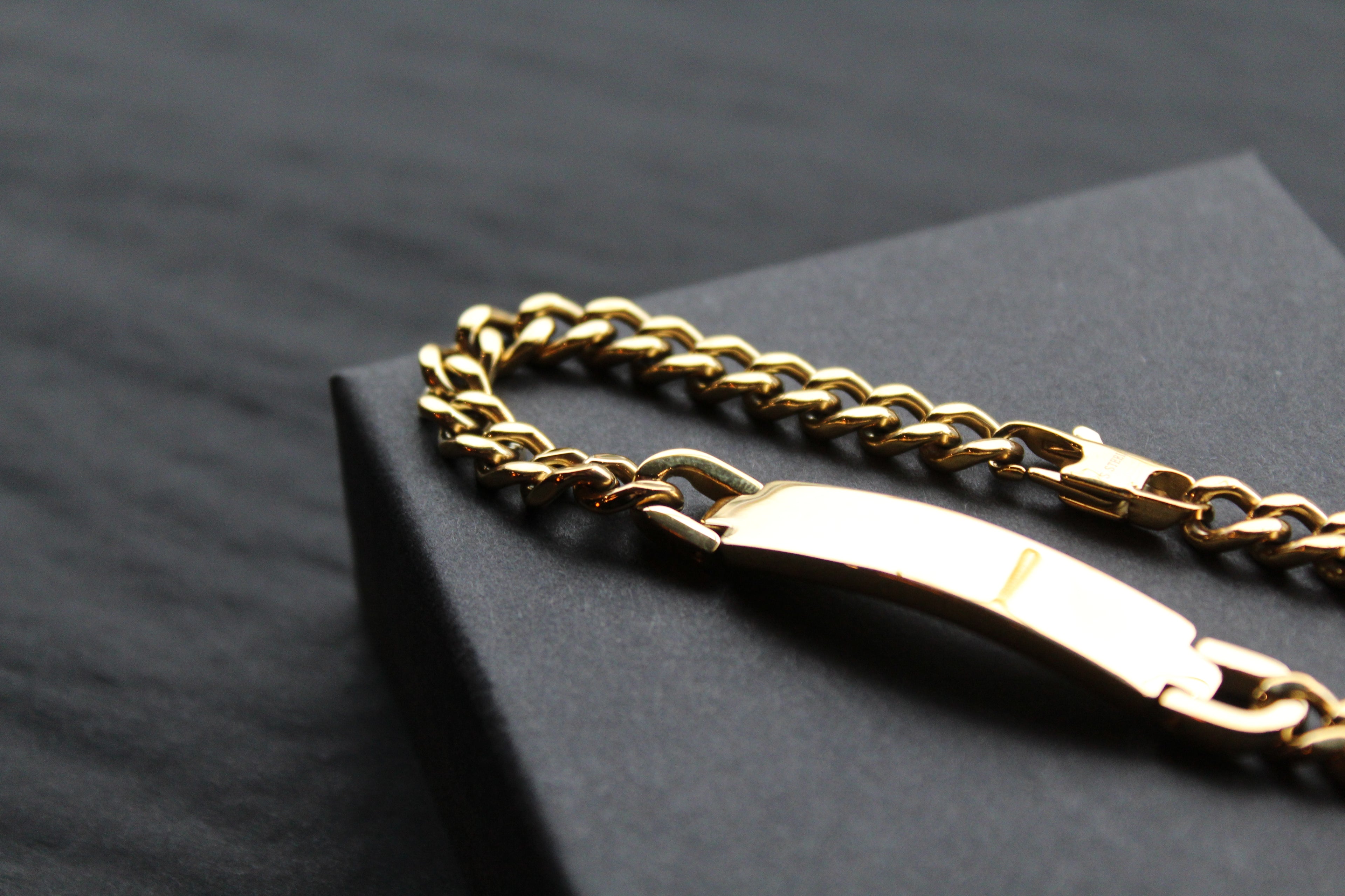 Stainless steel I.D curb bracelet with gold IP plating.