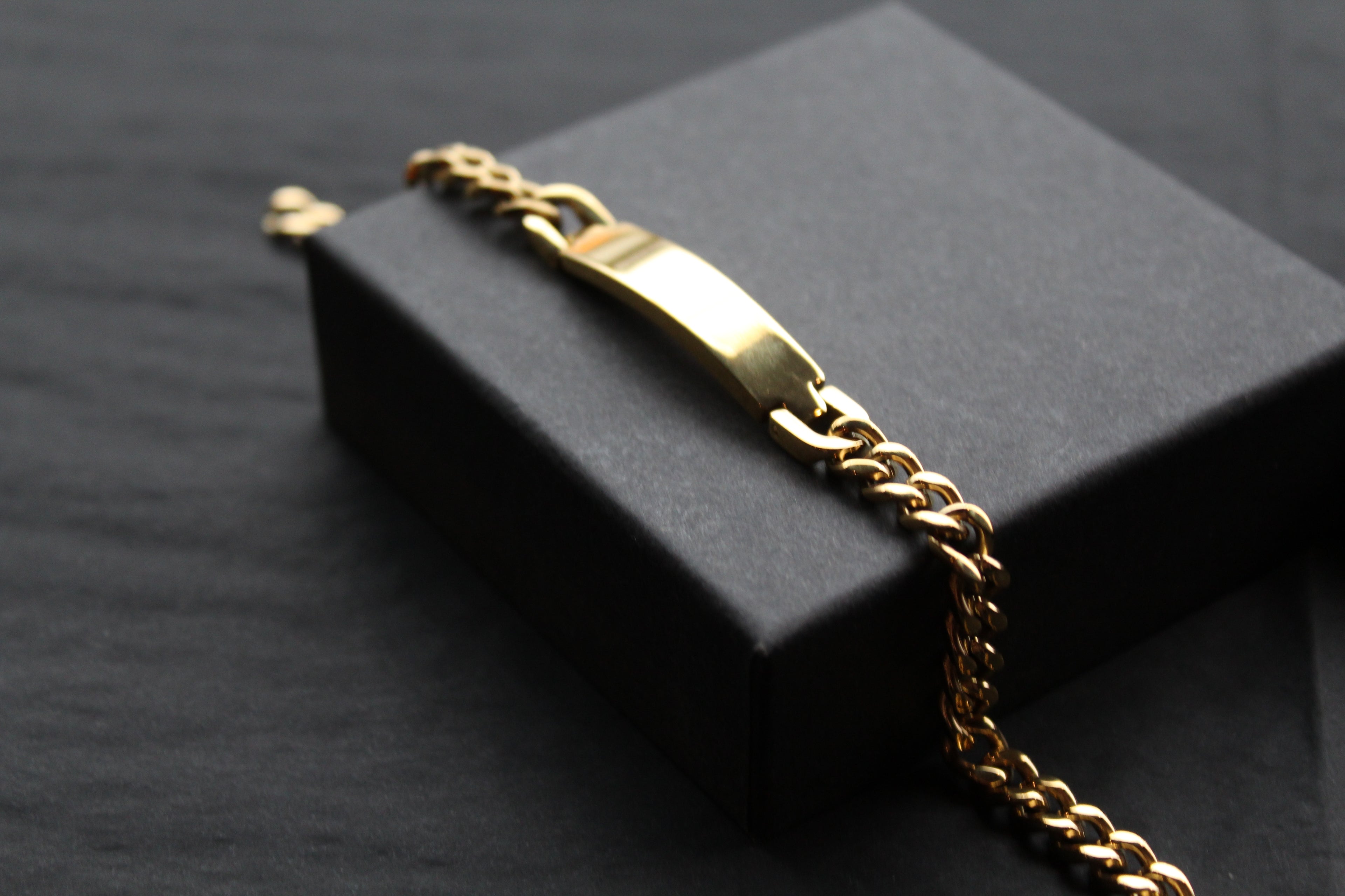 Stainless steel I.D curb bracelet with gold IP plating.