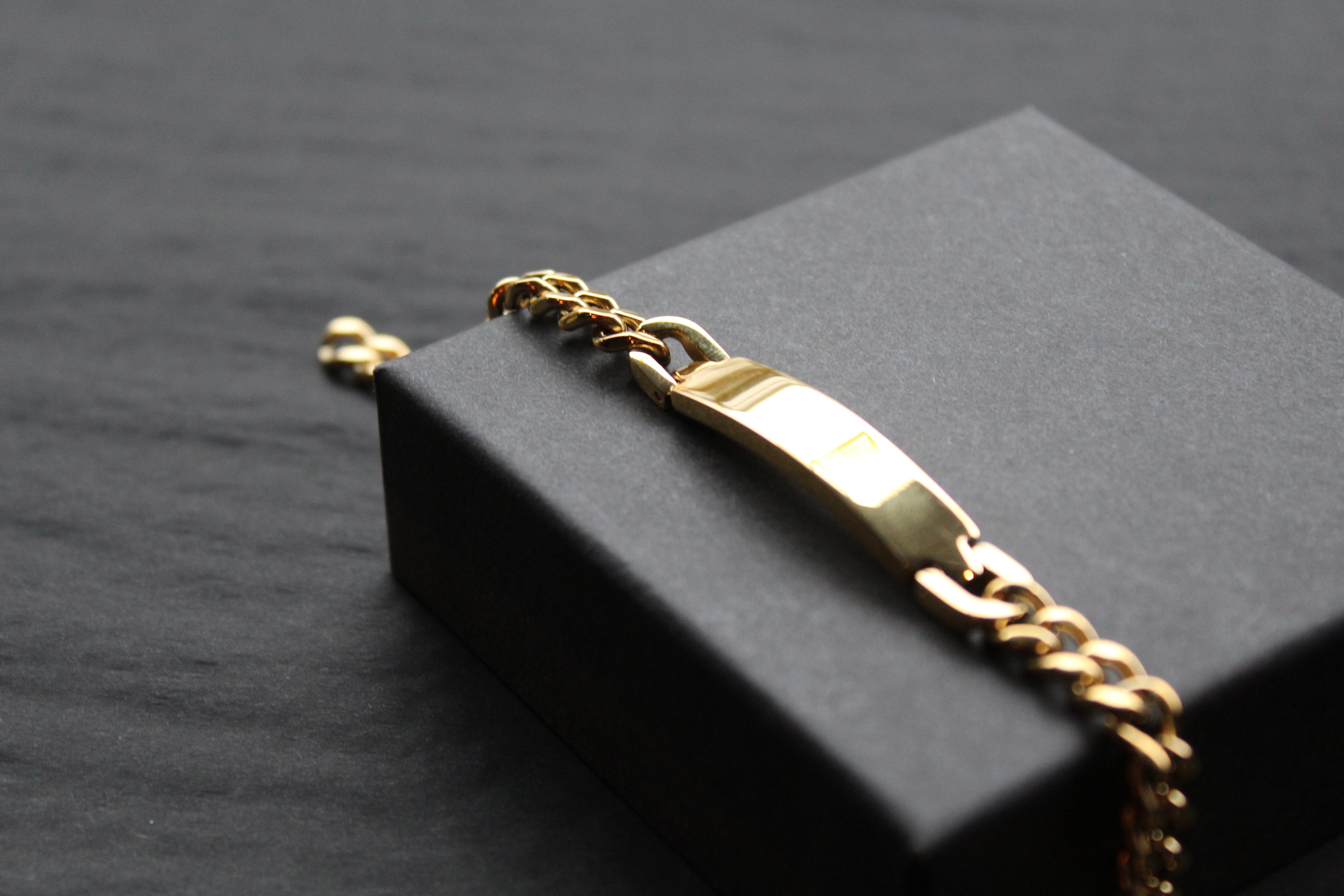 Stainless steel I.D curb bracelet with gold IP plating.