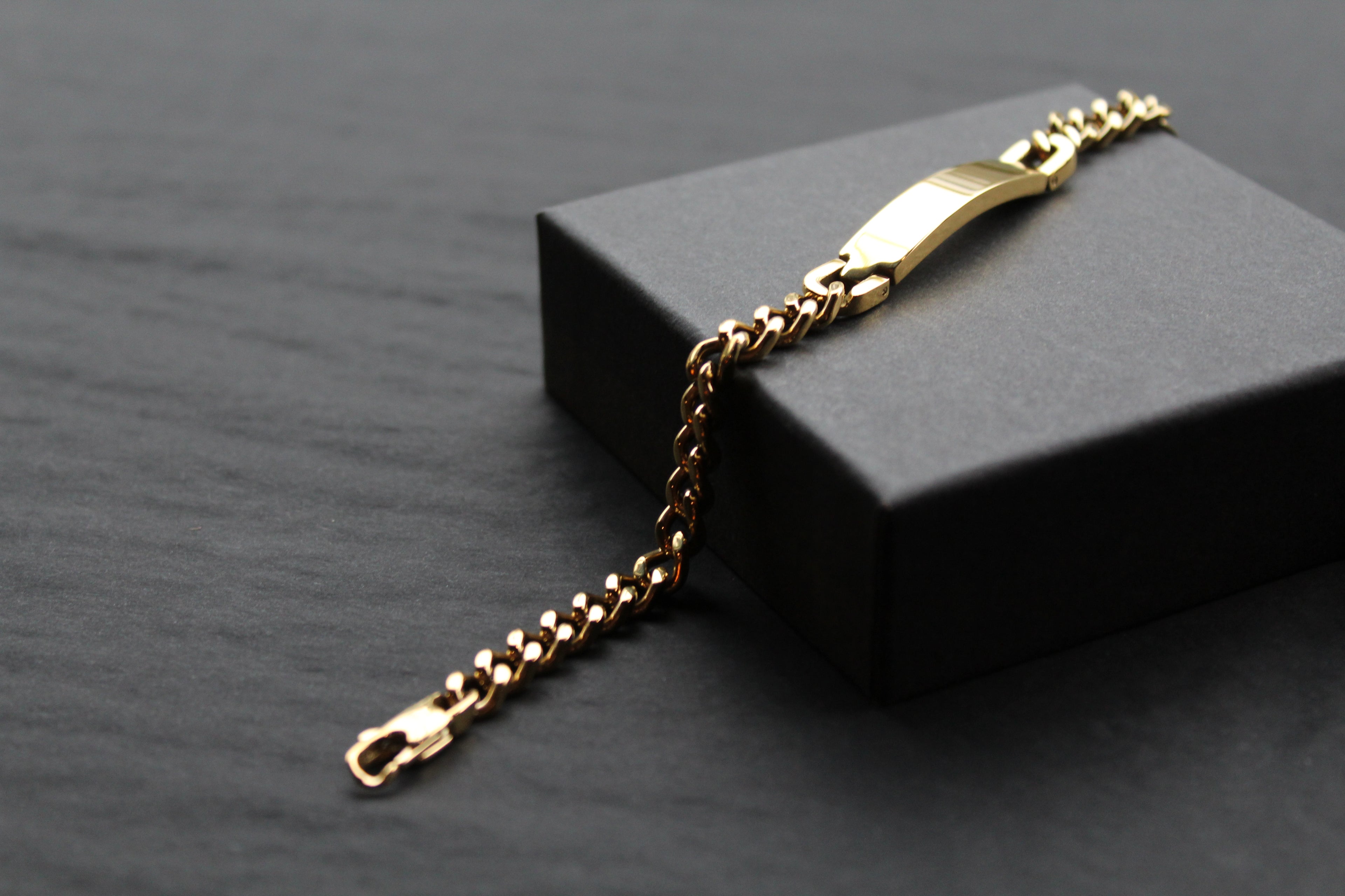 Stainless steel I.D curb bracelet with gold IP plating.