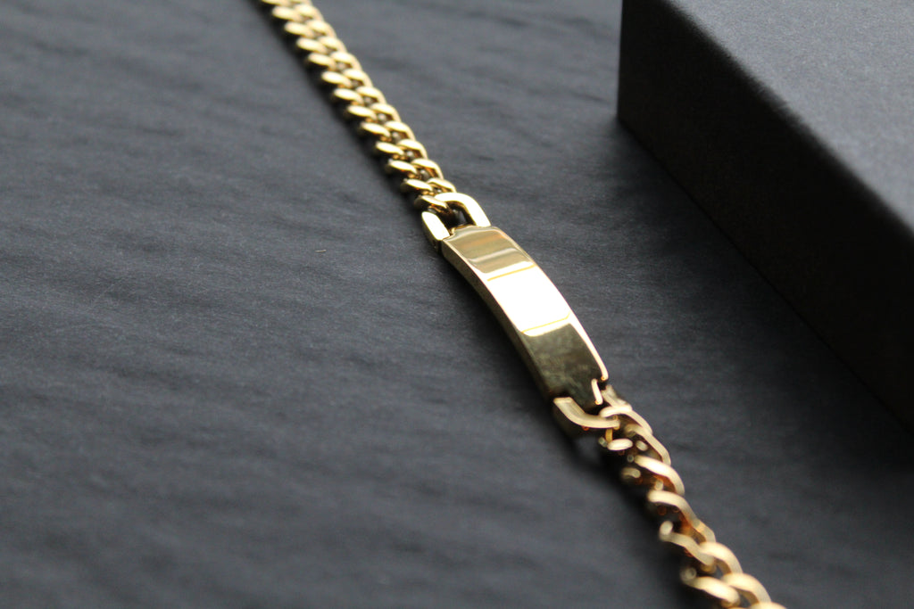 Stainless steel I.D curb bracelet with gold IP plating.